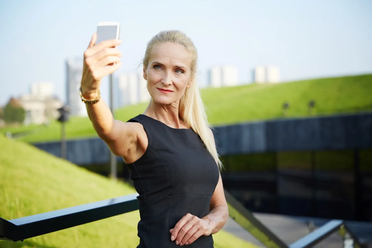 Confident older woman taking a selfie