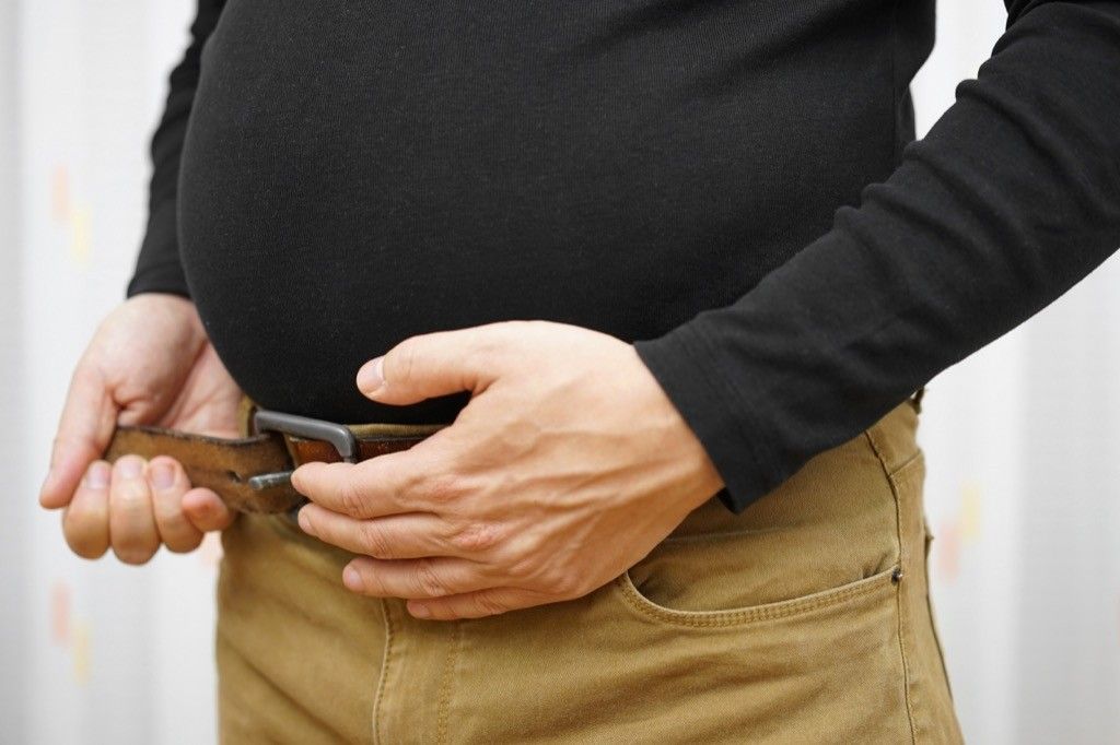 Man adjusting his belt.