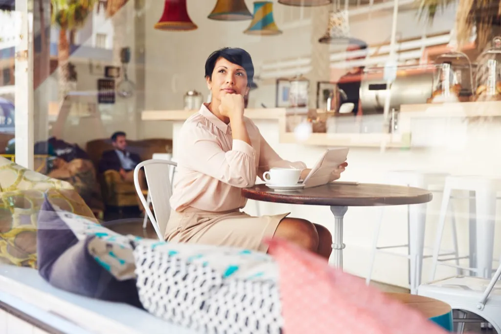 woman looking out the window at a coffee shop, things divorced people know