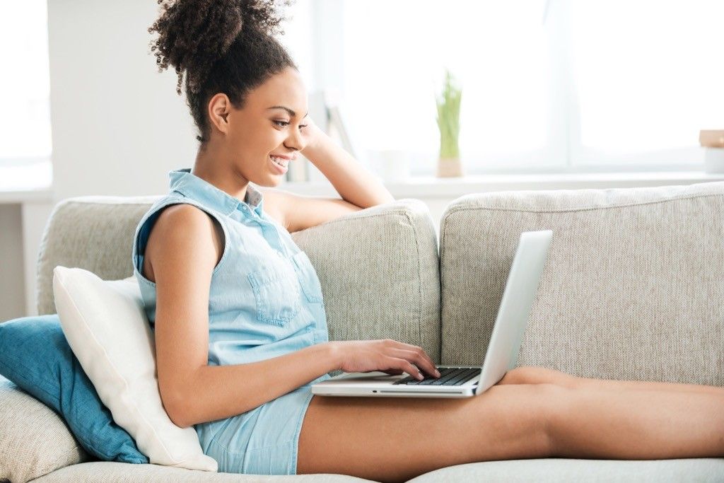 woman on laptop booking cheap flights