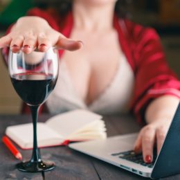 woman turns down glass of wine