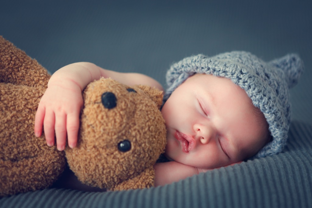 baby sleeping and hugging teddy bear - literary baby names 