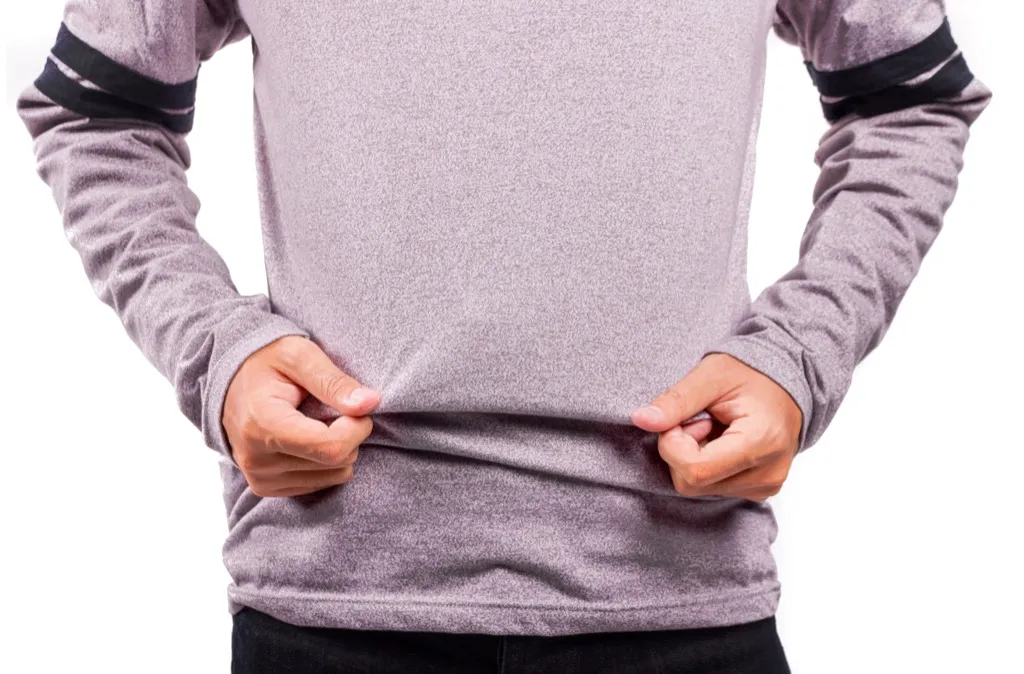 man tugging at a sweatshirt - how to dress over 50 