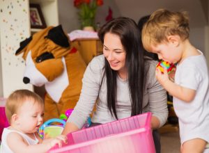 babysitter playing with kids, working mom