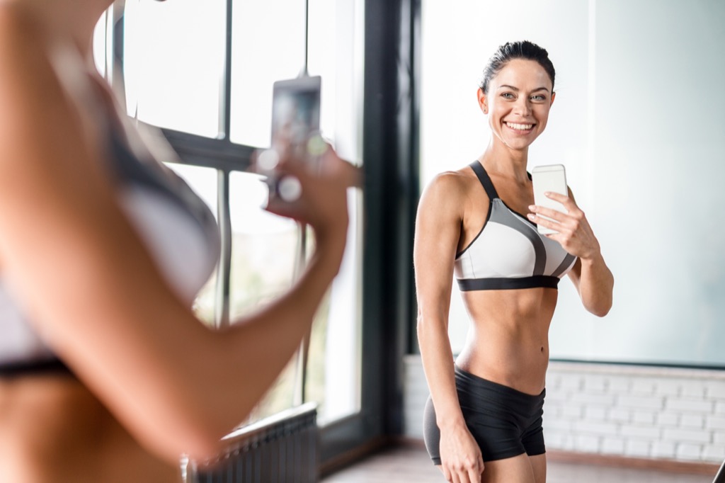 fitness woman posing for selfie in mirror