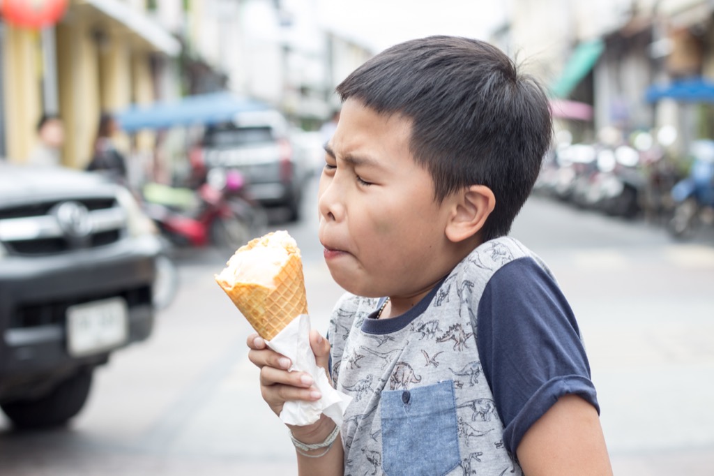 kid eating ice cream having a brain freeze