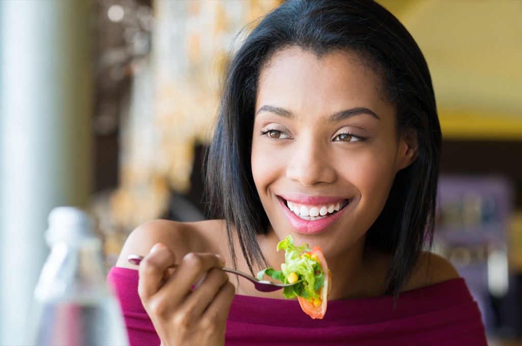 woman eating salad health tweaks over 40. 