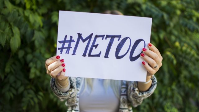 Woman holding a #MeToo sign