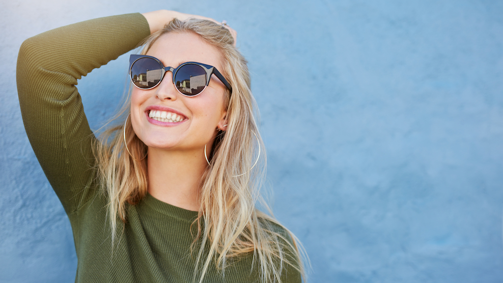 woman smiling and wearing sunglasses, how to dress over 40