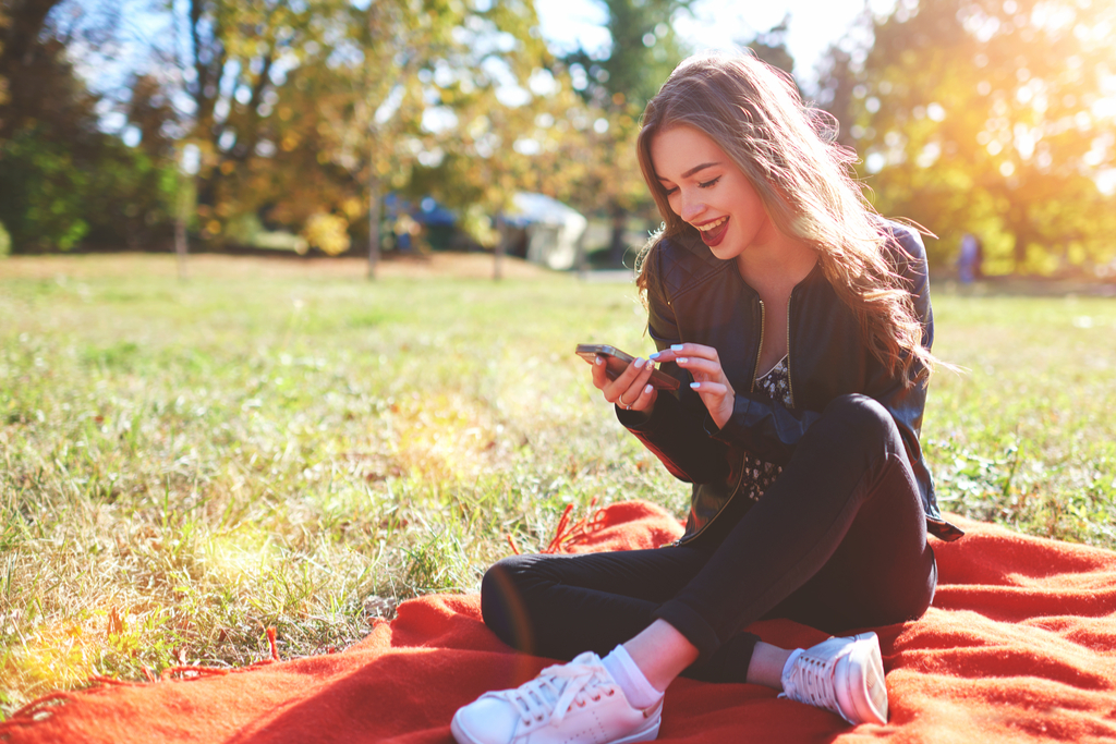 Girl Smiling at Phone Social Media