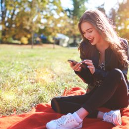 Girl Smiling at Phone Romance