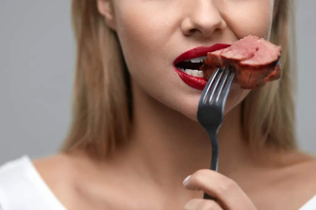 Woman Eating Steak ways we're unhealthy