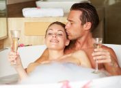 couple drinking champagne in a bubble bath, smart person habits