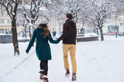 Cute couple having a good time outside in the snow