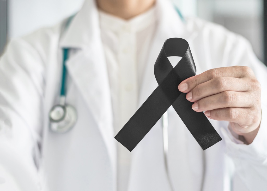 doctor holding skin cancer ribbon