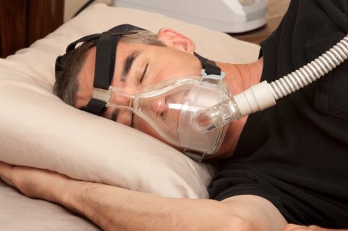 middle aged white man in cpap mask for sleep apnea