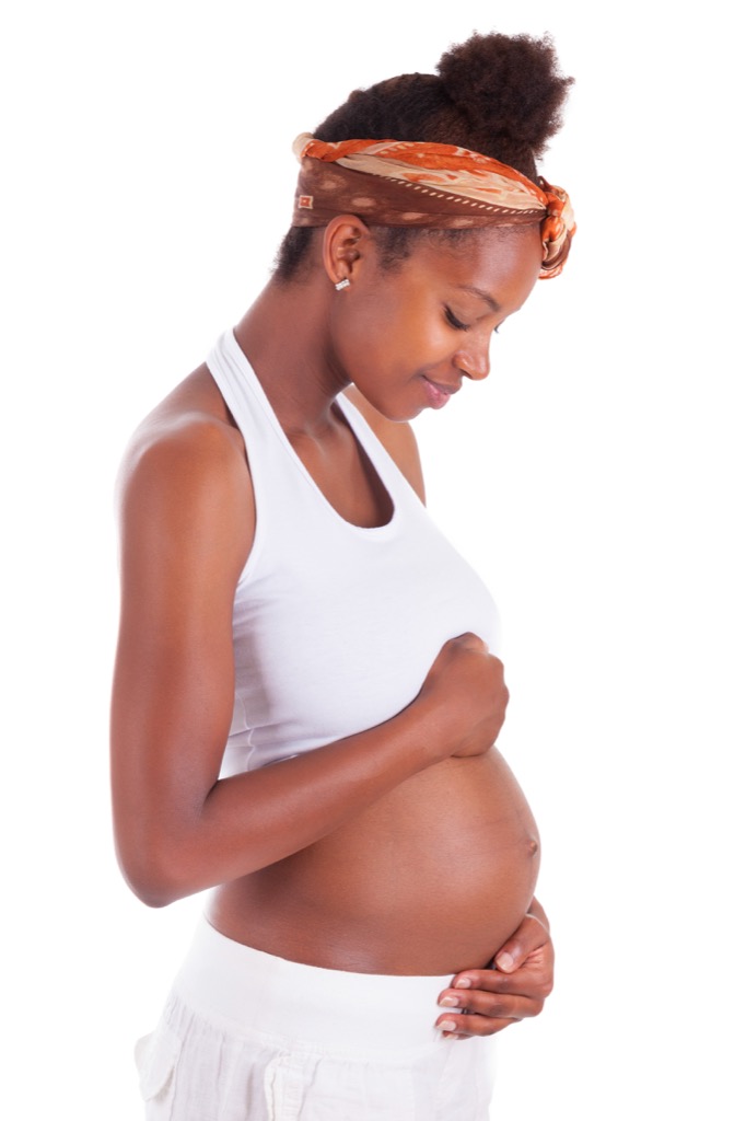 pregnant woman holding her stomach 
