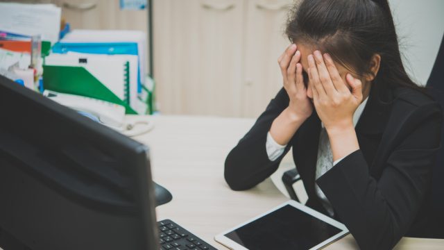 stock photo of woman frustrated at work.
