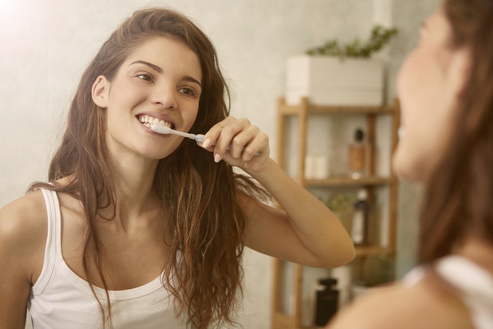 woman brushes teeth