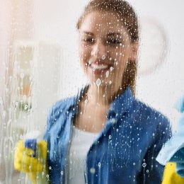 woman cleaning window, working mom