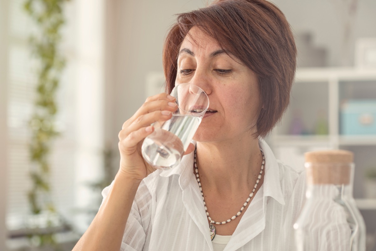Older woman drinking a glass of water