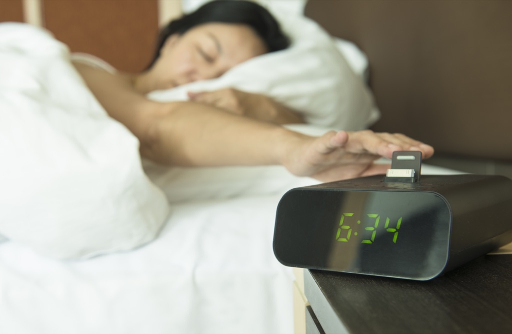 woman turning off alarm perfect nap
