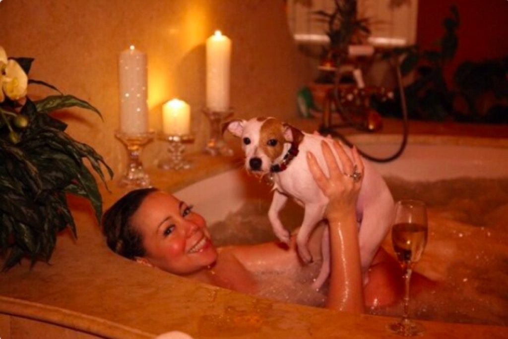 Mariah Carey and a dog in a bathtub