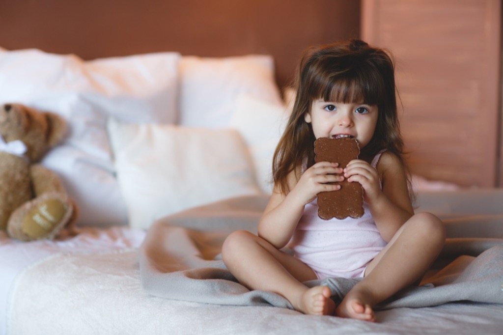 little girl eating chocolate, bad parenting advice