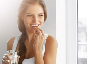 Woman taking supplement