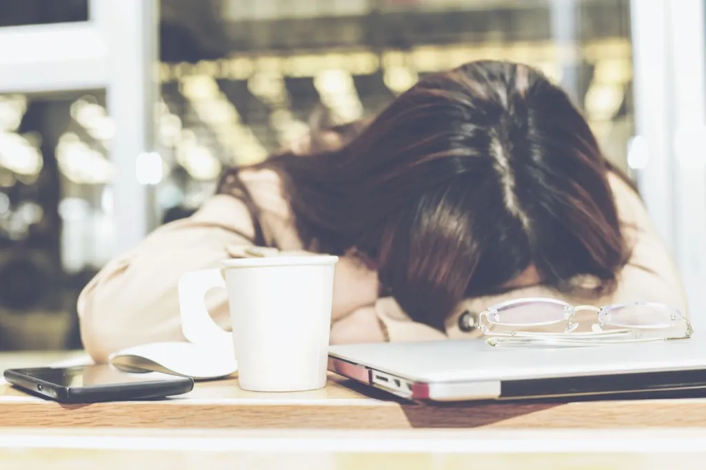 woman sleeping at desk alzheimers symptom