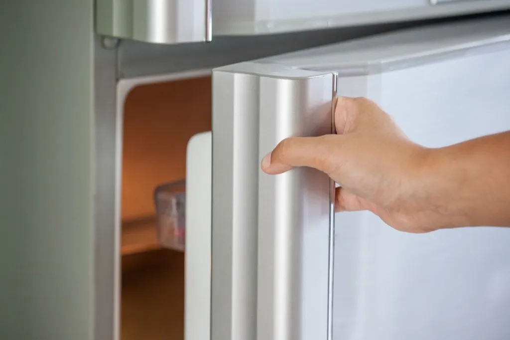 man opening fridge