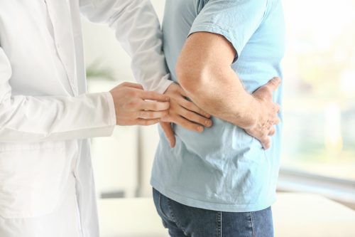 closeup of a doctor examining a patient's kidneys