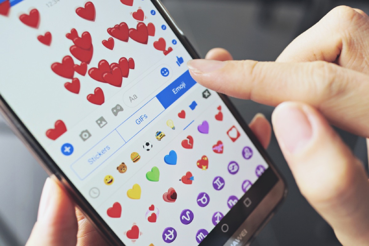 woman sending heart emojis via text, etiquette mistakes