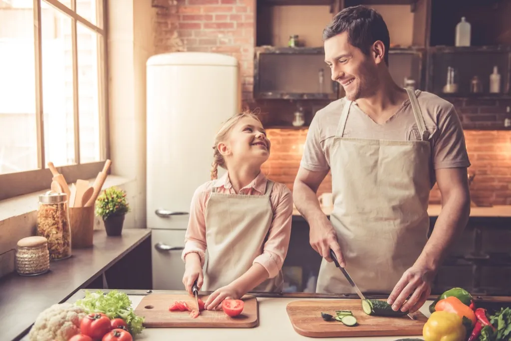 Dad and daughter cooking Worst Things to Say to Kids