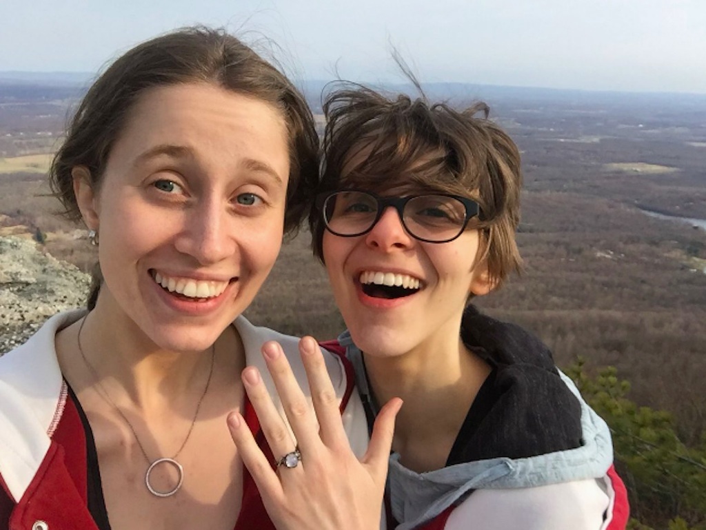 Meg proposes to Lyd on top of a mountain using Instant photos.