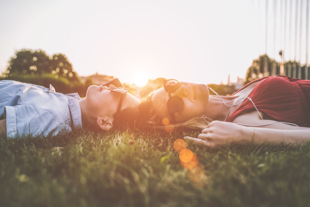 lying in grass outside daily health hacks