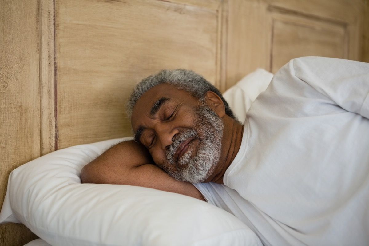 A senior black man is sleeping soundly