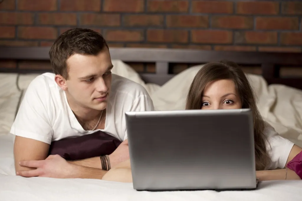 man trying to distract wife at computer