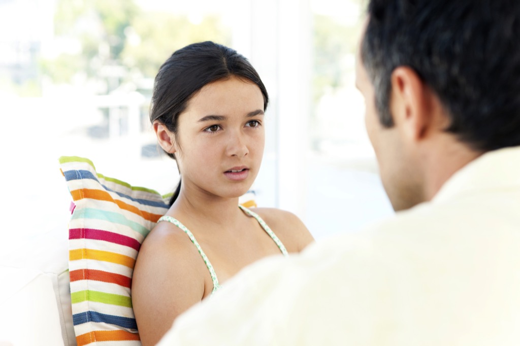 teen talking to dad, https://bestlifeonline.com/holiday-stress/