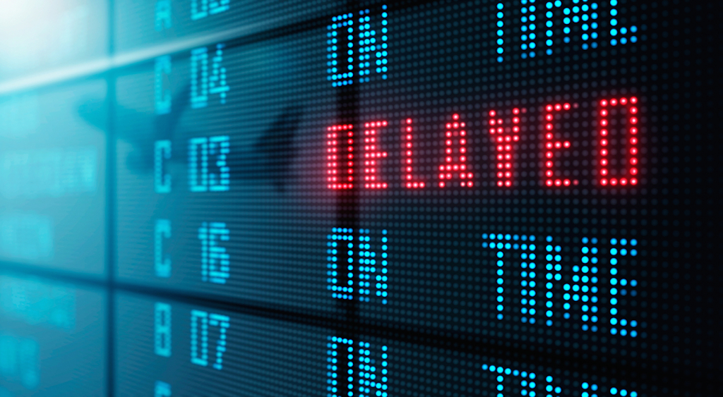 airport board shows flight delay