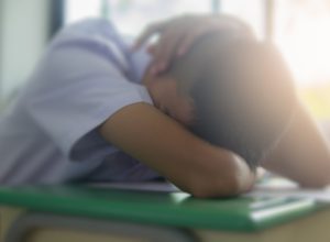 student sleeping at desk