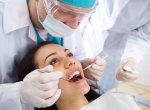 Woman getting her teeth looked at at the dentist's office