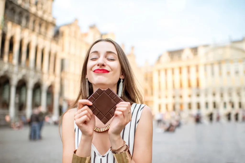 woman eating dark chocolate Surprising Weight-Loss Tips
