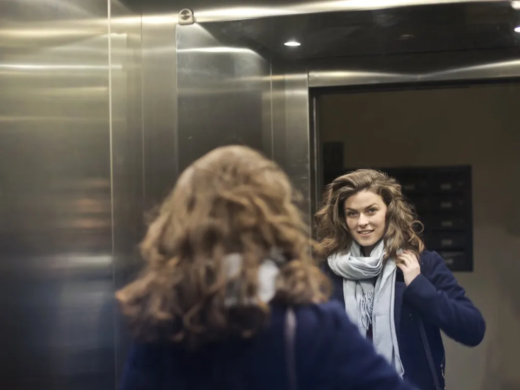 woman waiting and fixing scarf elevator