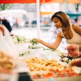 Black woman shopping for vegetables at the farmer's market