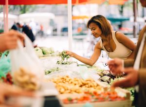 Black woman shopping for vegetables at the farmer's market
