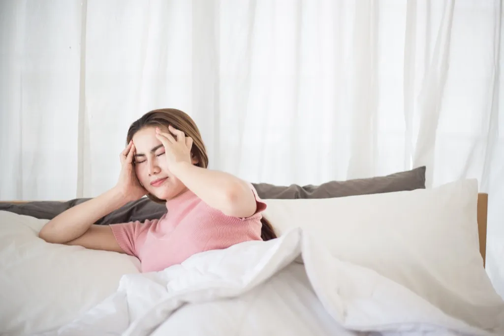 Woman is Dizzy in Bed Heart Attack Signs