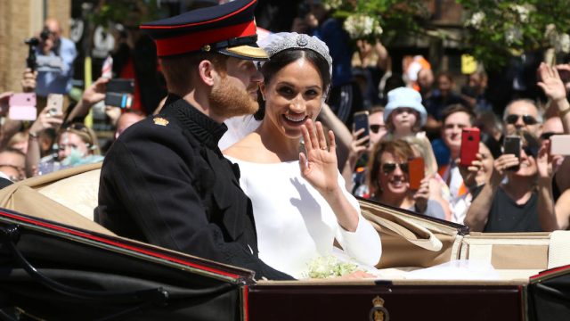 The Duke and Duchess of Sussex, Meghan Markle and HRH Prince Harry (of Wales) give a wave to the crowd after their wedding