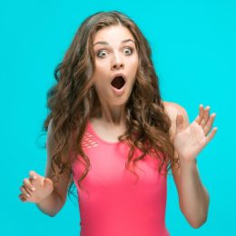 astonished woman blue background