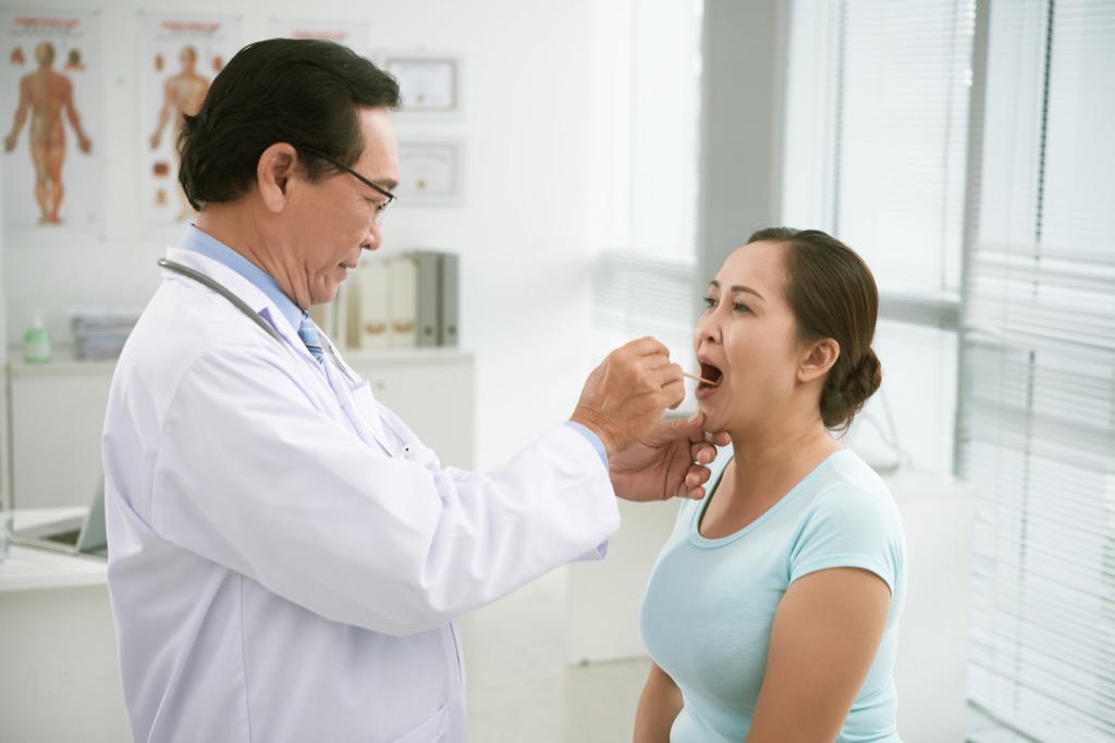 doctor inspecting tonsils